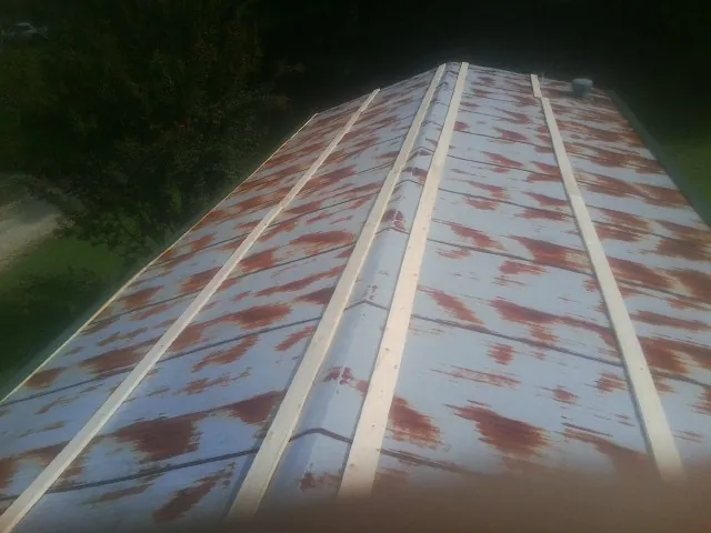 Rusted metal roof panels with new wood purlins before replacement — Storm Damage Roof Repair in Cressey by Roofing Brothers